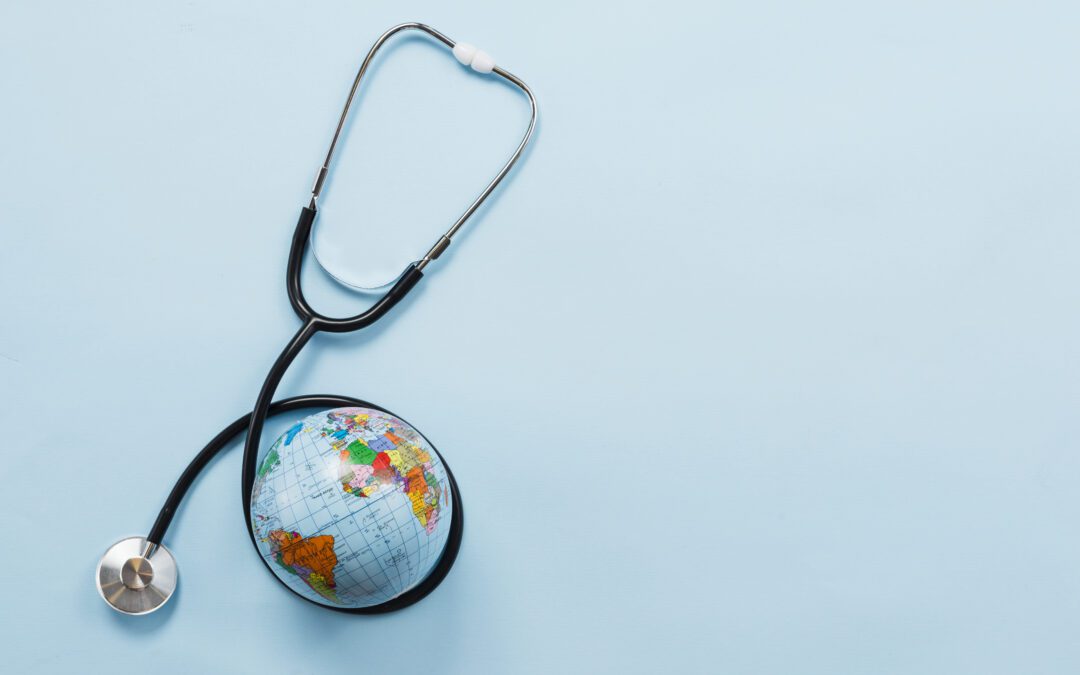 Stethoscope hugging earth on blue background