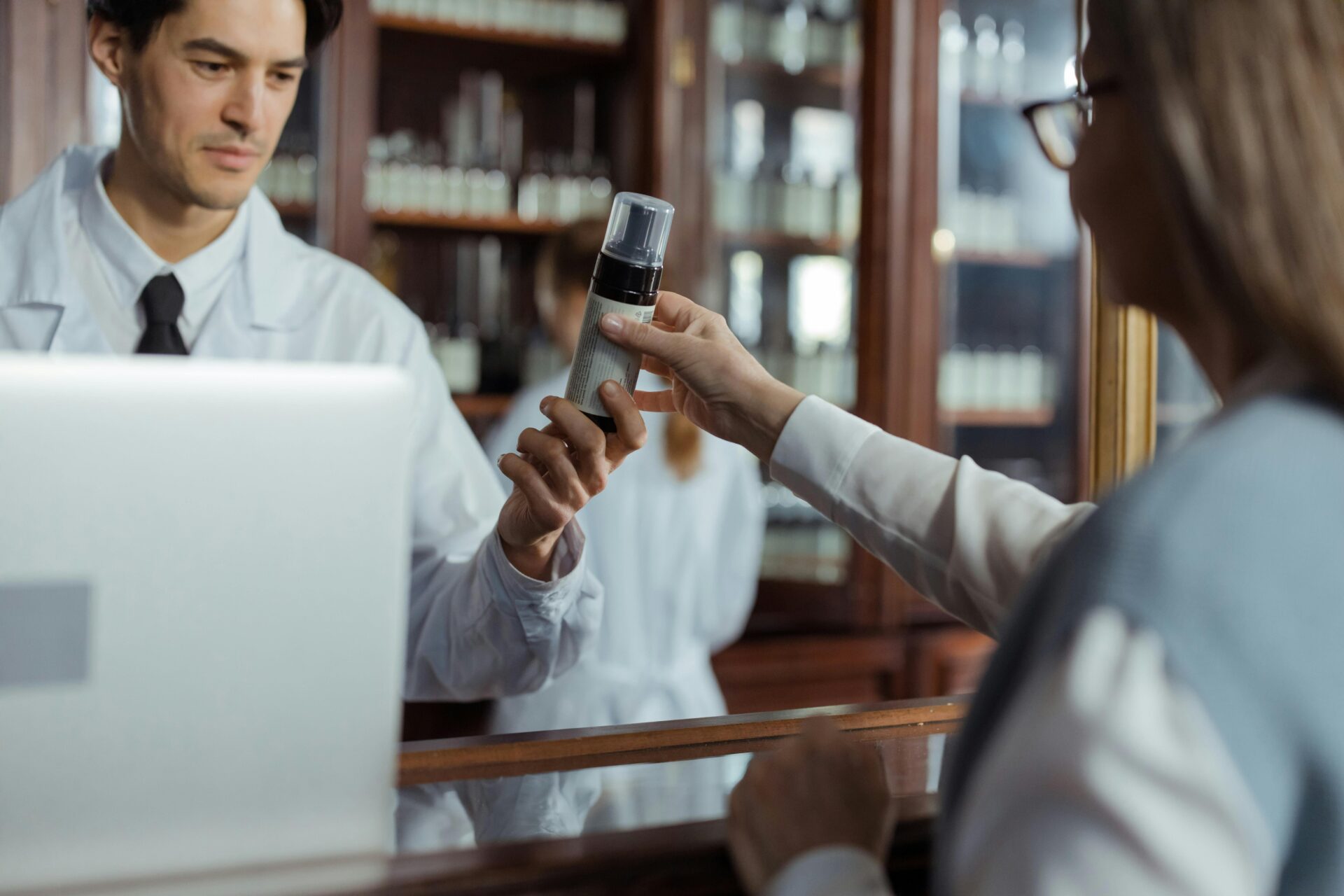 Image of a medical professional handing a pump medication to a woman.